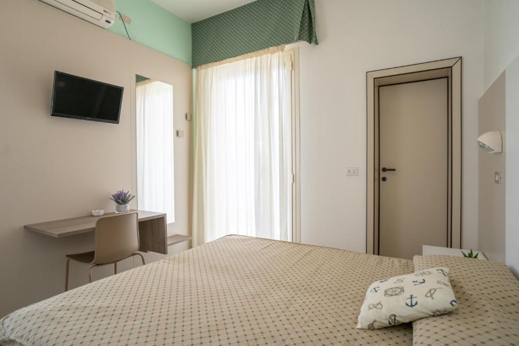 Postel nebo postele na pokoji v ubytování Hotel Marilinda