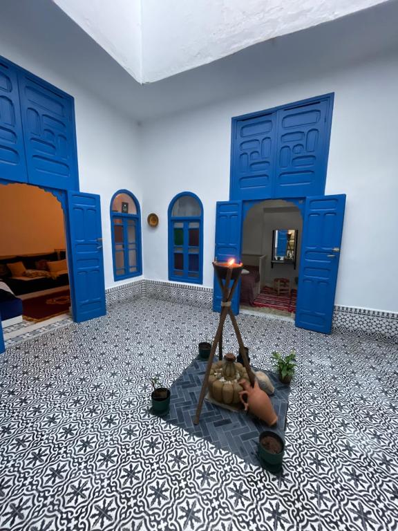 a room with blue doors and a room with a bed at Ba Ali in Rabat