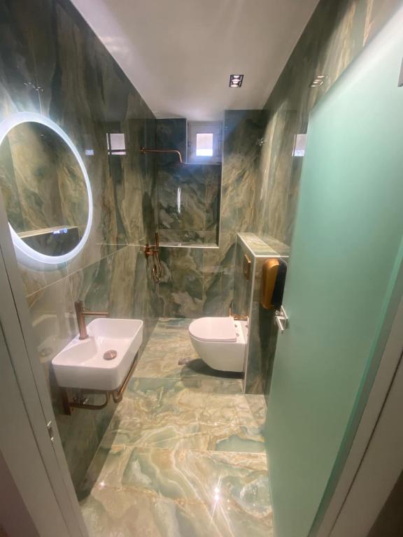 a bathroom with a sink and a toilet at Ador El Mar in Leptokarya