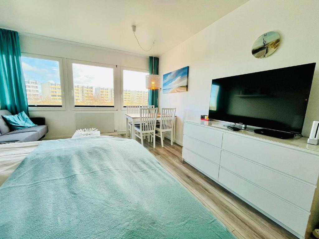 a bedroom with a large flat screen tv and a bed at Ferienwohnung Südanker Fehmarn in Fehmarn
