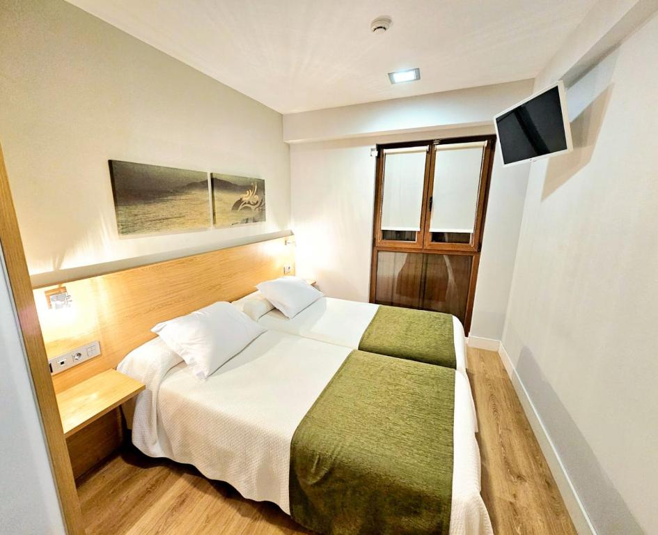 Postel nebo postele na pokoji v ubytování Hotel Olatu
