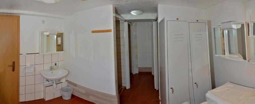 bagno bianco con lavandino e specchio di Camping Silva a Ljutomer