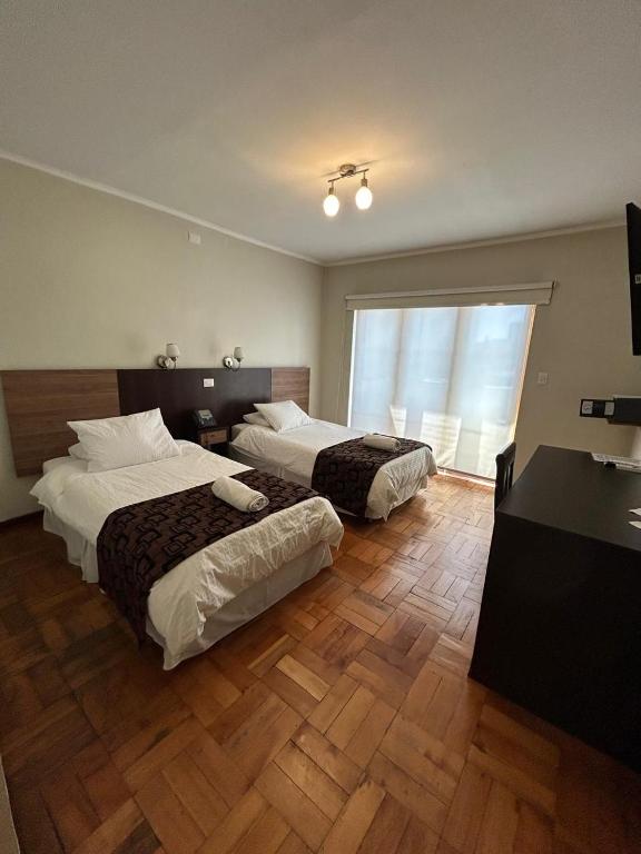 Postel nebo postele na pokoji v ubytování Hotel Plaza Ñuñoa
