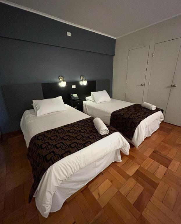 Postel nebo postele na pokoji v ubytování Hotel Plaza Ñuñoa