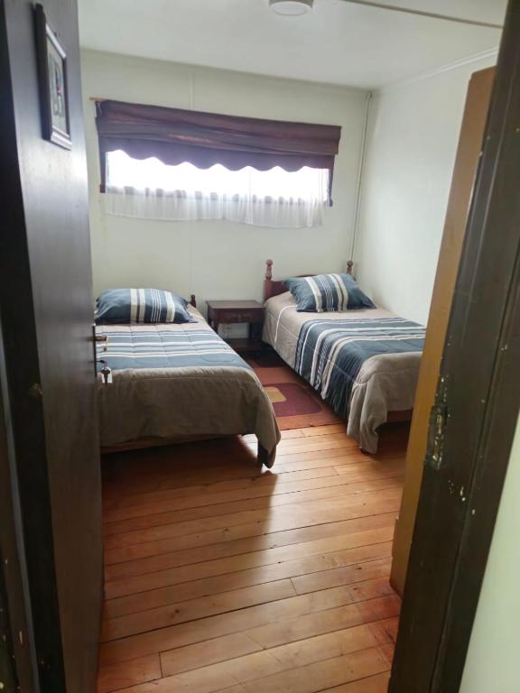 Postel nebo postele na pokoji v ubytování Hostal Esquina 601 Carampangue