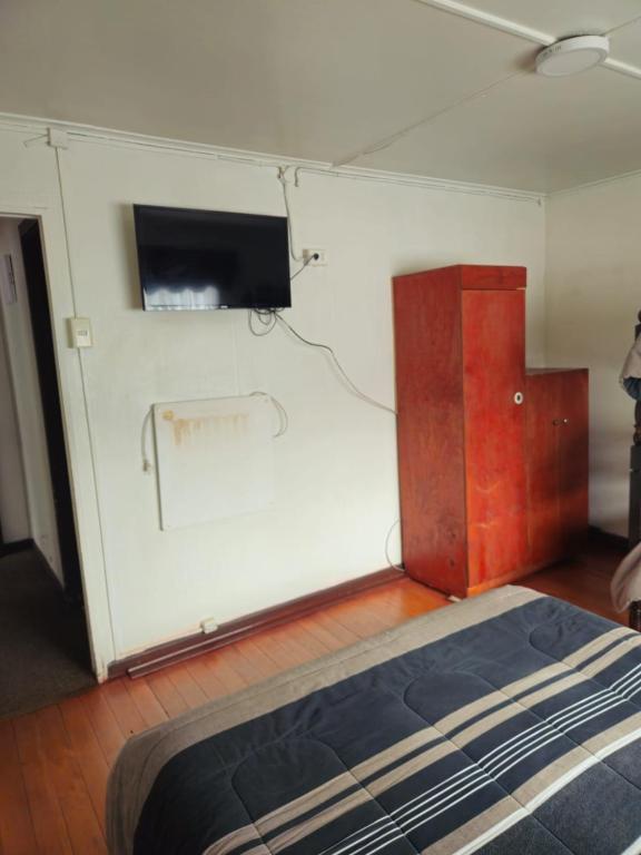 Postel nebo postele na pokoji v ubytování Hostal Esquina 601 Carampangue