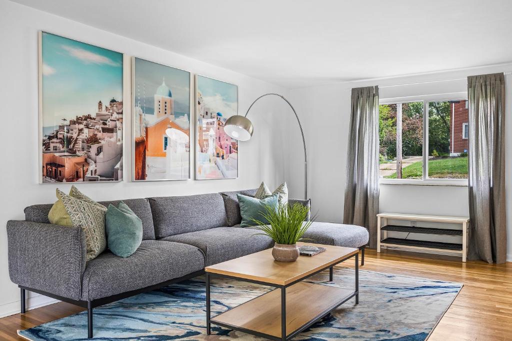 a living room with a couch and a table at Modern and Spacious House Pittsburgh in Pittsburgh