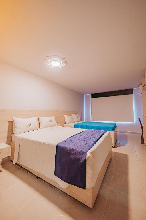 Postel nebo postele na pokoji v ubytování HOTEL VERANO