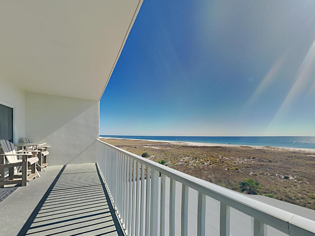 a view of the beach from the balcony of a house at Tidewater Orange Beach #202 in Orange Beach