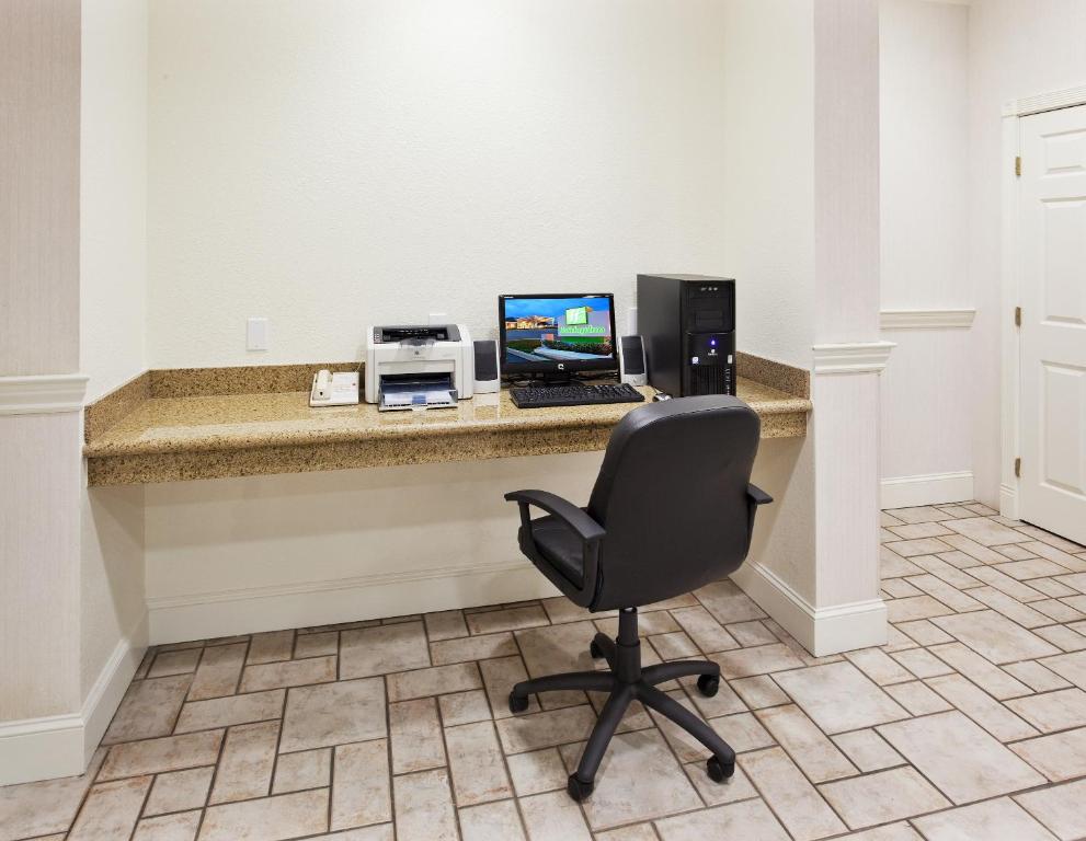 a desk with a laptop computer and a printer at Holiday Inn Redding by IHG in Redding