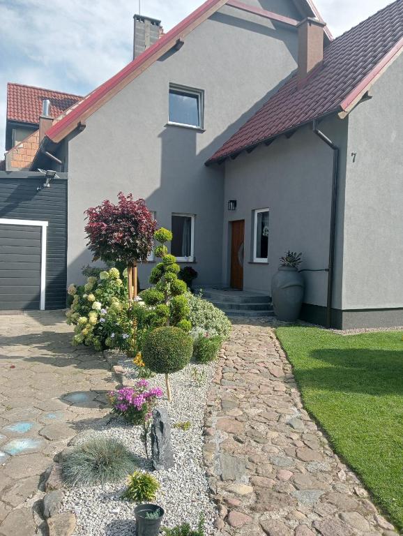 a house with a garden in front of it at Zakątek u Grzesia Gril & Chill in Trzebieszewo