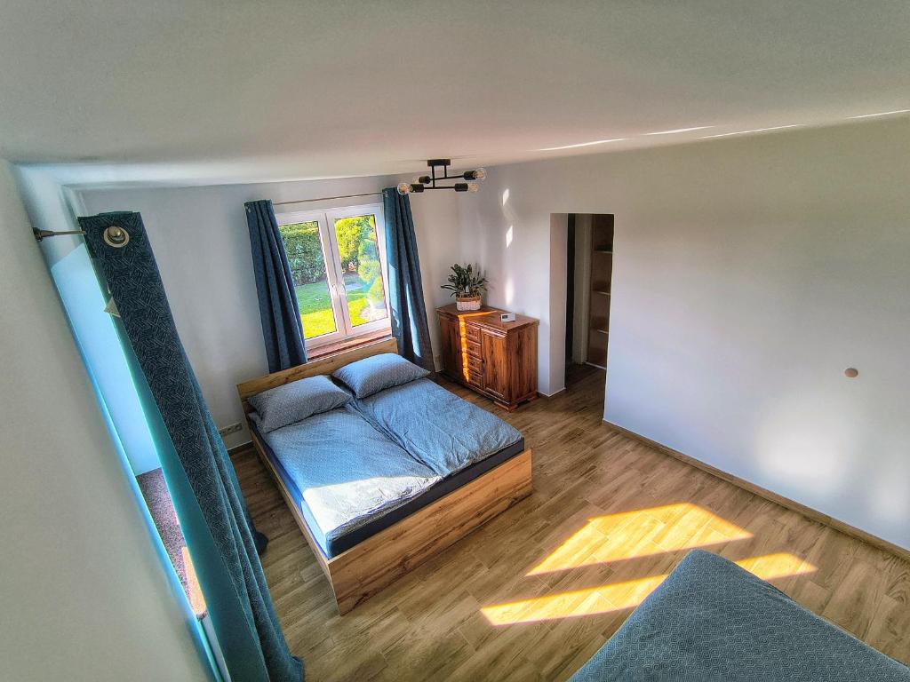 a bedroom with a bed and a window at Zakątek u Grzesia Gril & Chill in Trzebieszewo