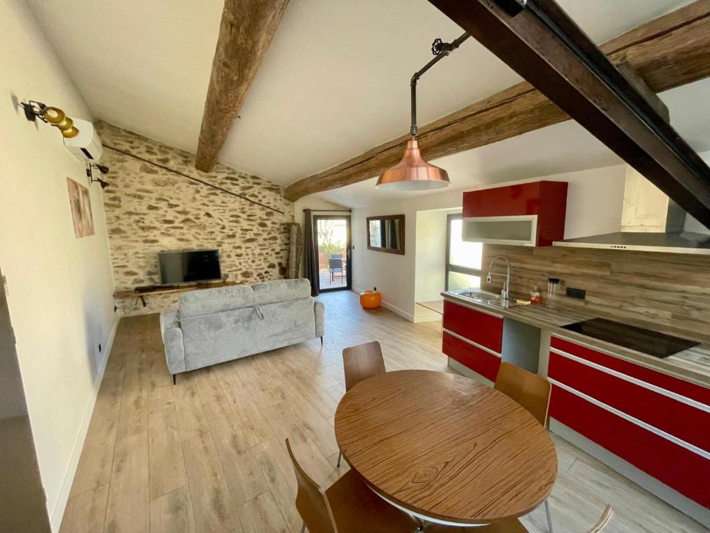 - une cuisine et un salon avec une table en bois dans la chambre dans l'établissement Gite charme et confort, à Sainte-Vallière