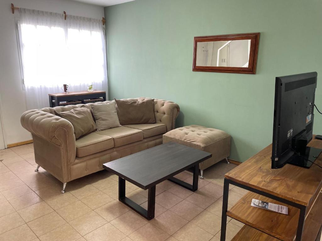a living room with a couch and a table at Tu espacio ideal, Amplia y Luminosa en Rio gallegos in Río Gallegos