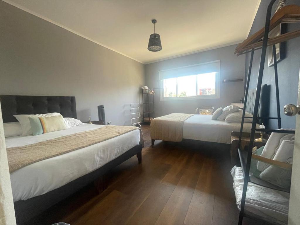 Postel nebo postele na pokoji v ubytování TQCaleta Providencia Barrio Italia