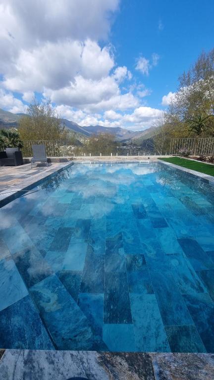 a large swimming pool with blue water at Casa Picone - Gerês in Ventosa