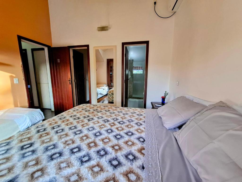 Postel nebo postele na pokoji v ubytování Vila Palmar Hospedagem