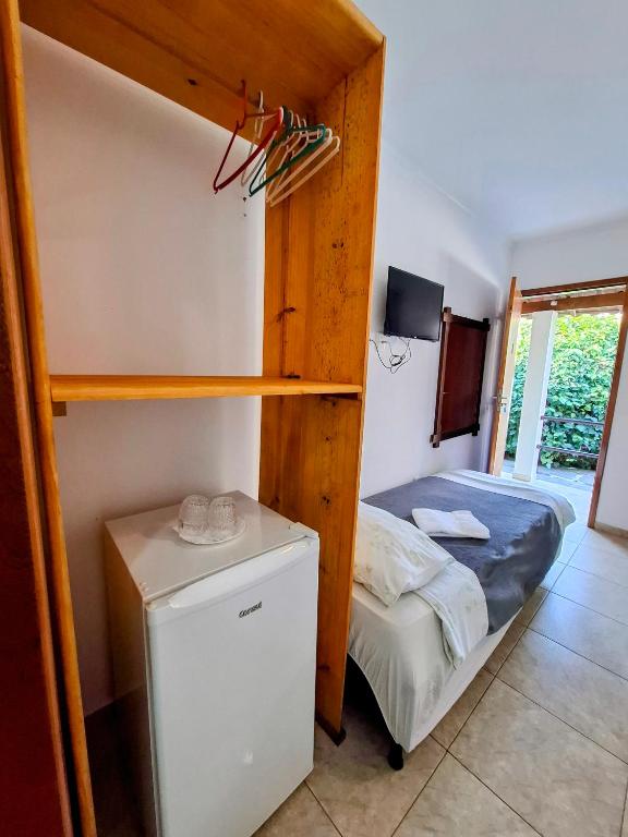 Postel nebo postele na pokoji v ubytování Vila Palmar Hospedagem