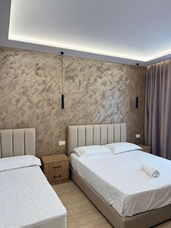Postel nebo postele na pokoji v ubytování Moonlight Hotel