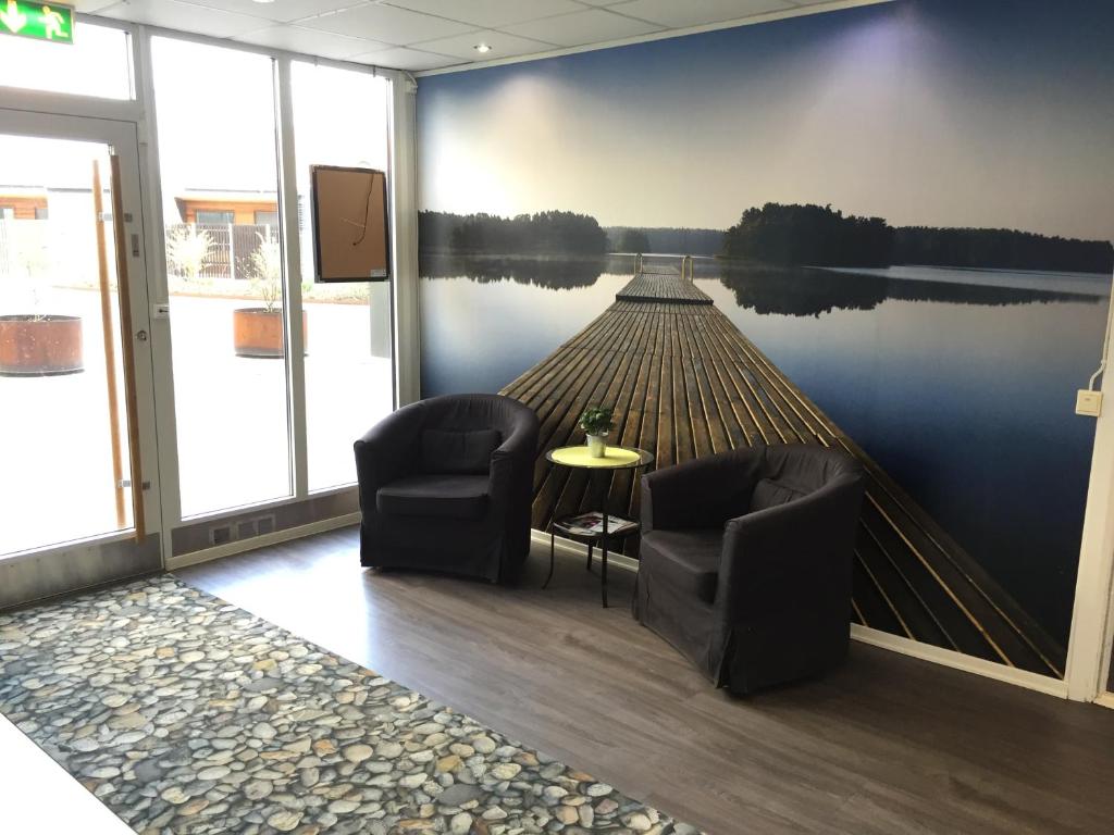 a room with a painting of a dock on the water at Masthuggsterrassens Hostel in Gothenburg