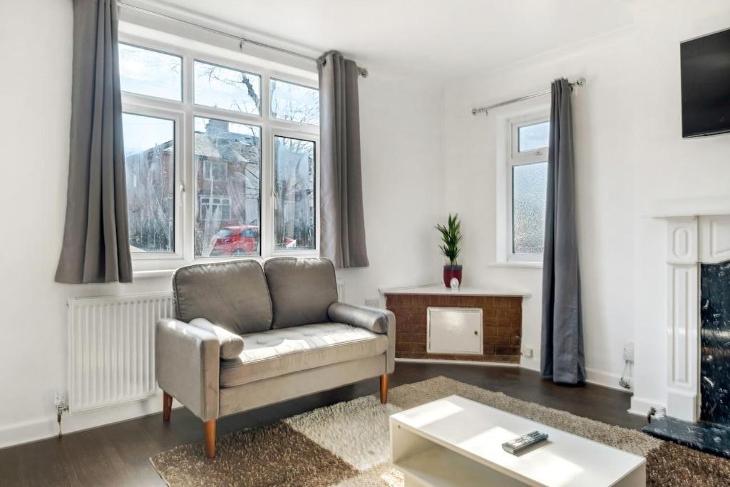 a living room with a couch and a fireplace at Comfy Home-Vimy Road in Birmingham