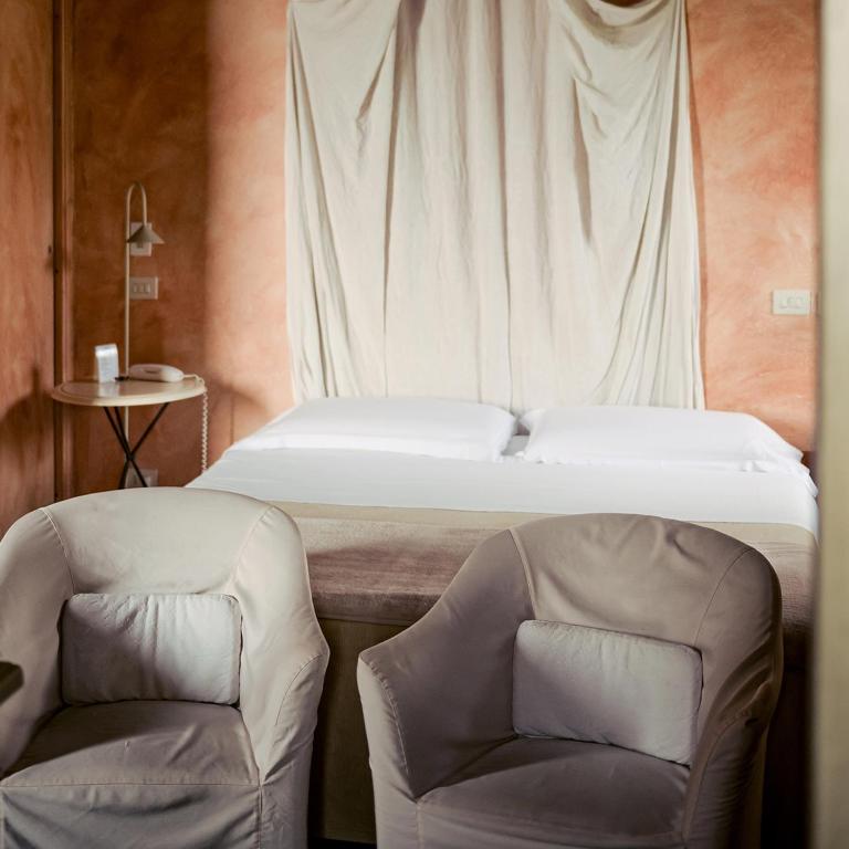 Postel nebo postele na pokoji v ubytování Cappuccini Resort