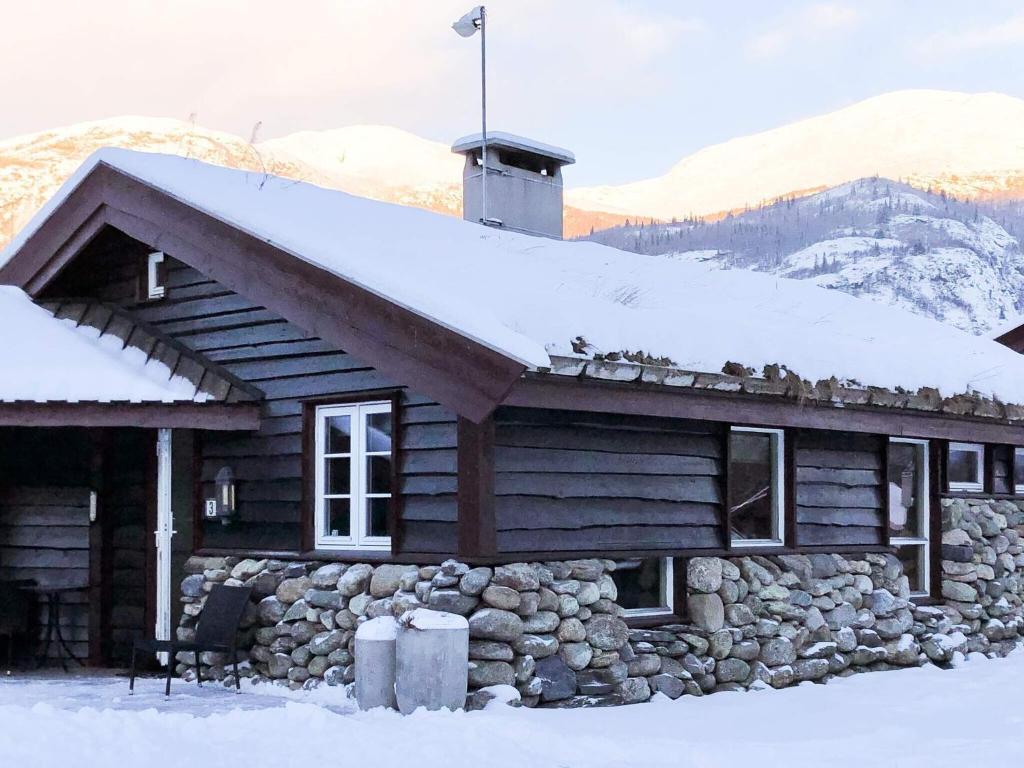 a log cabin with snow on top of it at 8 person holiday home in Hemsedal in Hemsedal