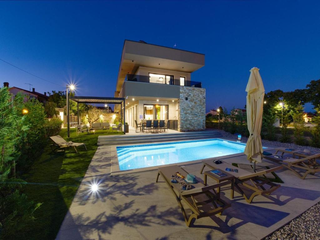 a villa with a swimming pool at night at Villa in Marcana with Pool near Brijuni Park in Marčana