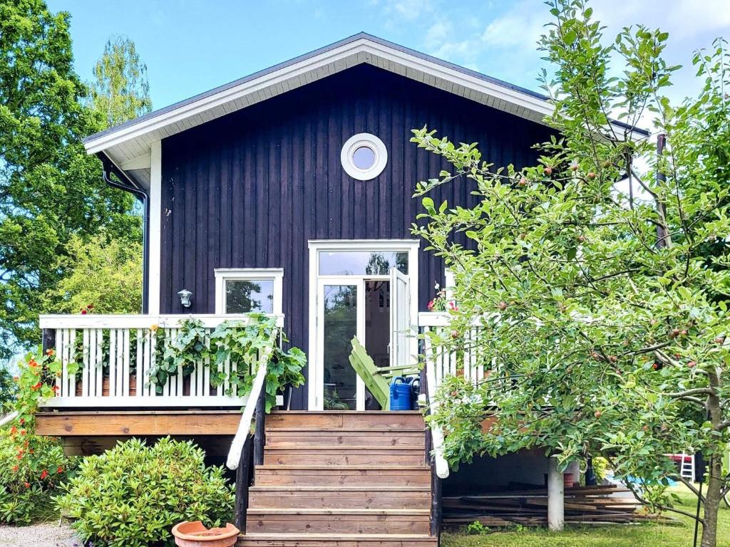 a blue house with a porch and a staircase at 4 star holiday home in FRÄNDEFORS in Frändefors
