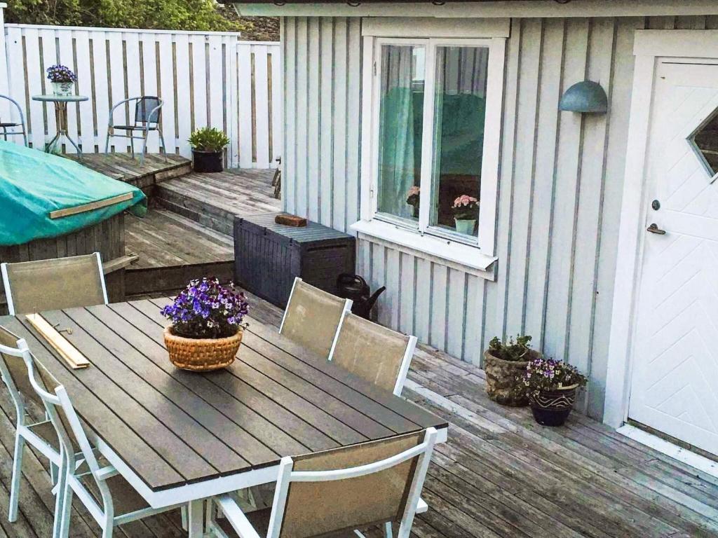 a wooden table and chairs on a patio at Quiet Island Retreat on Hono in Hönö