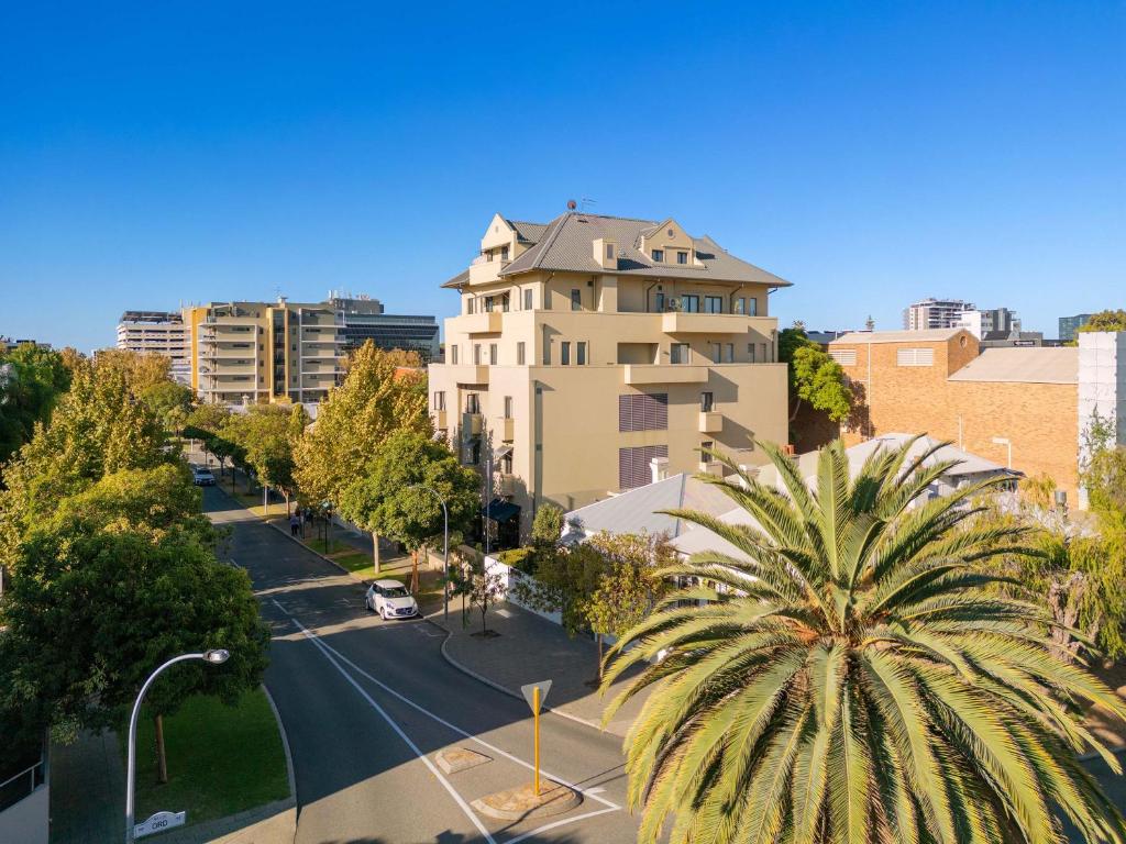a city street with a palm tree in front of a building at Club Wyndham Perth, Trademark Collection by Wyndham in Perth