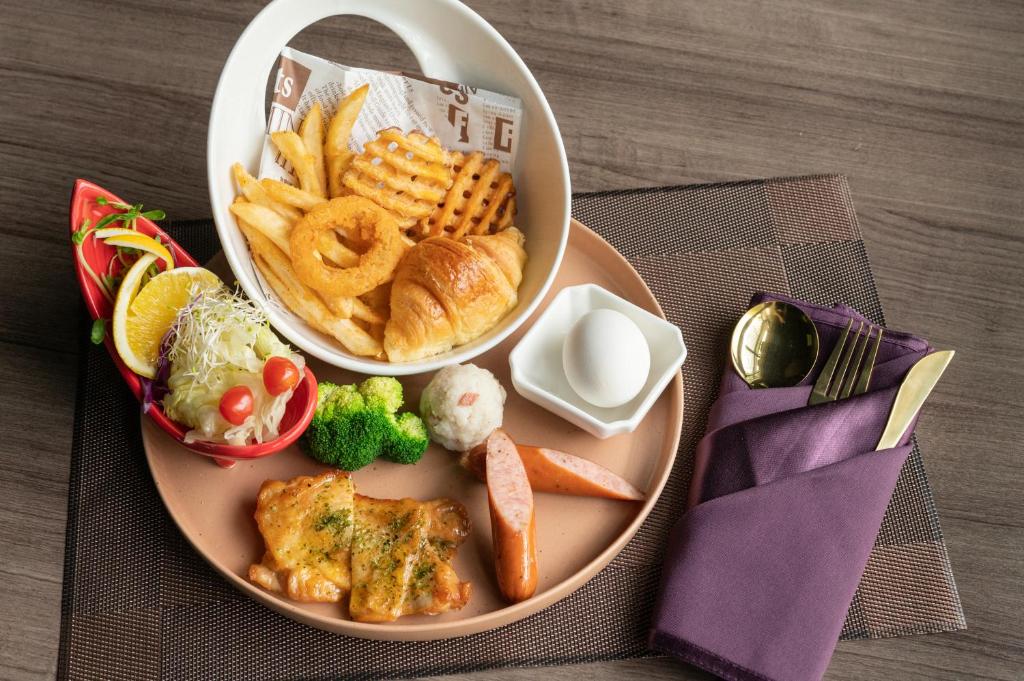 a plate of food with a bowl of waffles and fries at TH Hotel in Pingtung City