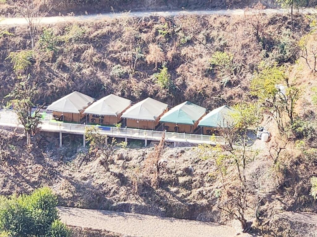 a train on a bridge on a mountain at Palki Camps and Resorts in Kailāna