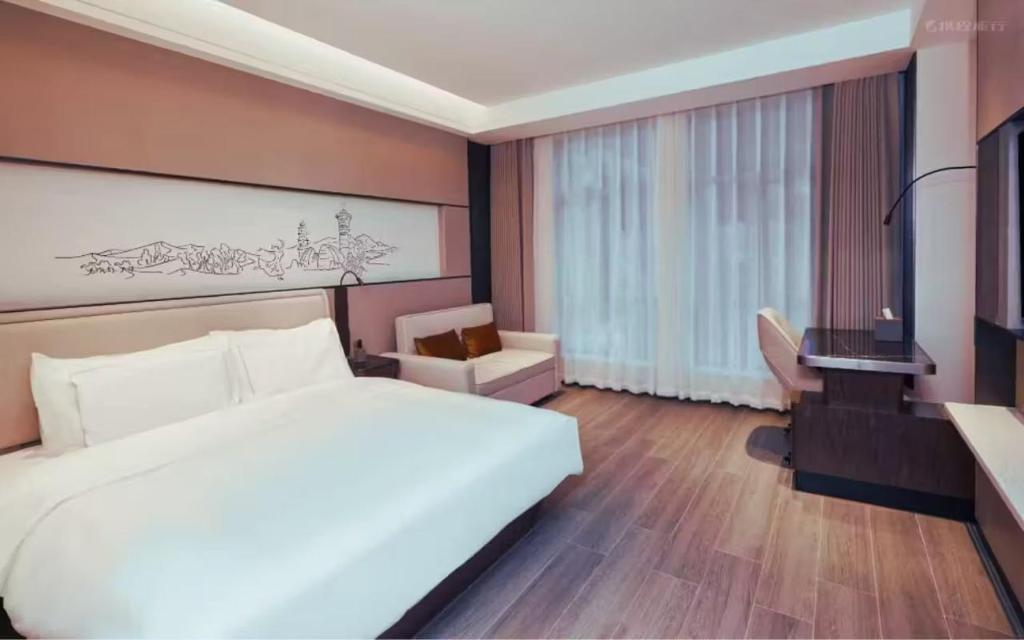 Postel nebo postele na pokoji v ubytování UrCove by HYATT Aksu