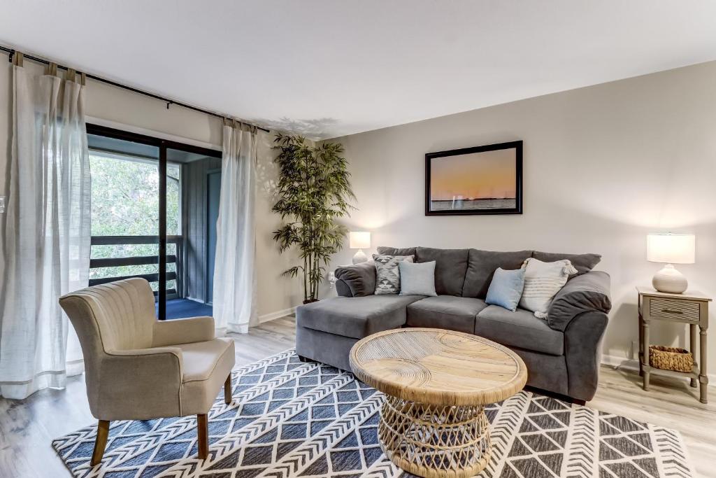 a living room with a couch and a table at 3E Amelia Landings condo in Fernandina Beach