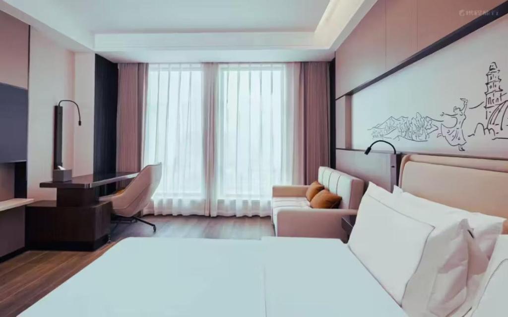 Postel nebo postele na pokoji v ubytování UrCove by HYATT Aksu