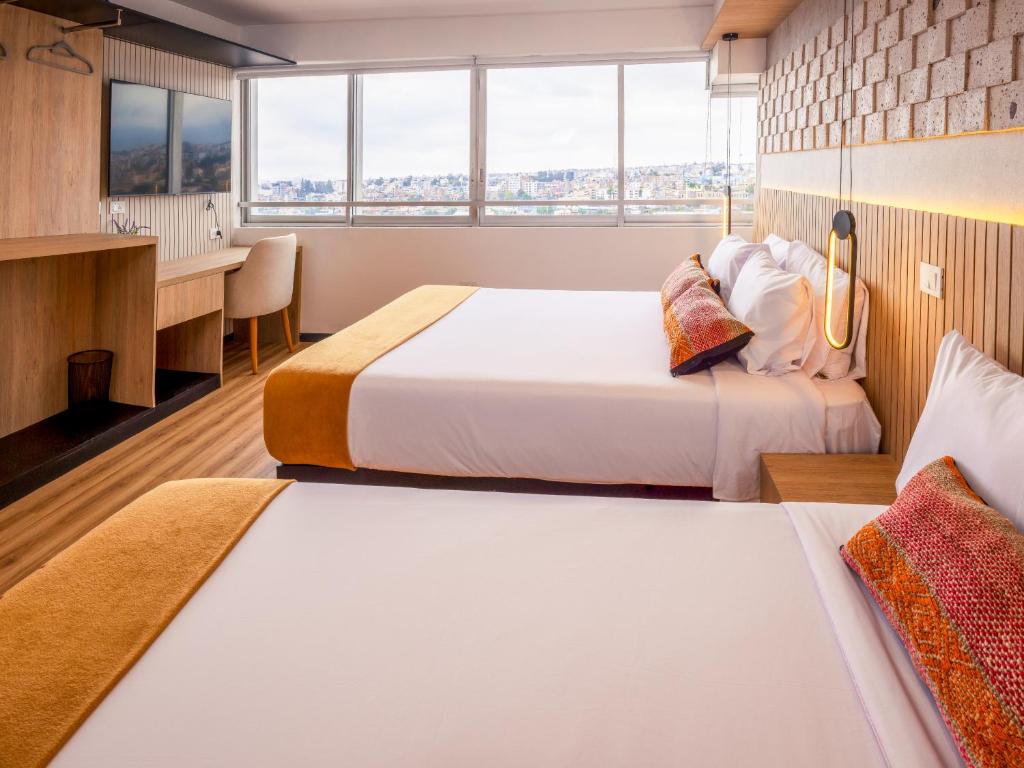 Postel nebo postele na pokoji v ubytování Le Foyer Flats Sudamerica Rooms