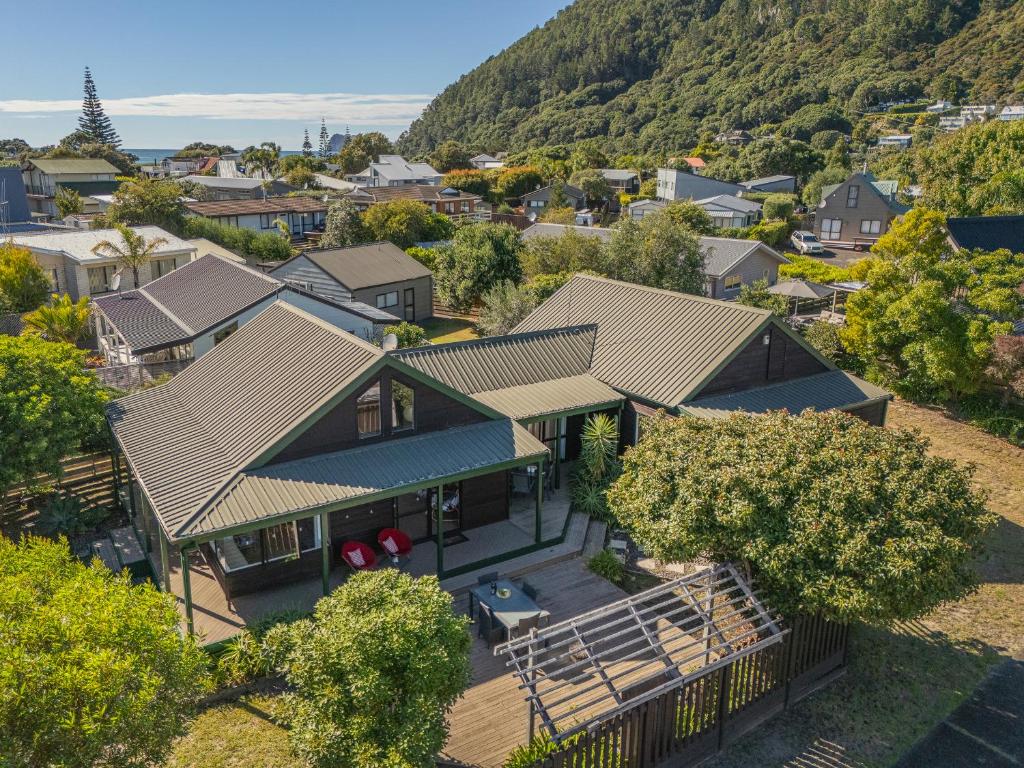 an aerial view of a house in a village at Beaumont Beach Retreat - Pauanui Holiday Home in Pauanui