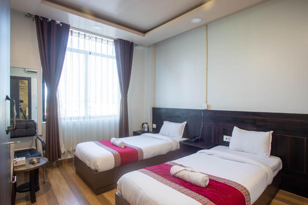 Postel nebo postele na pokoji v ubytování The SR Hotel