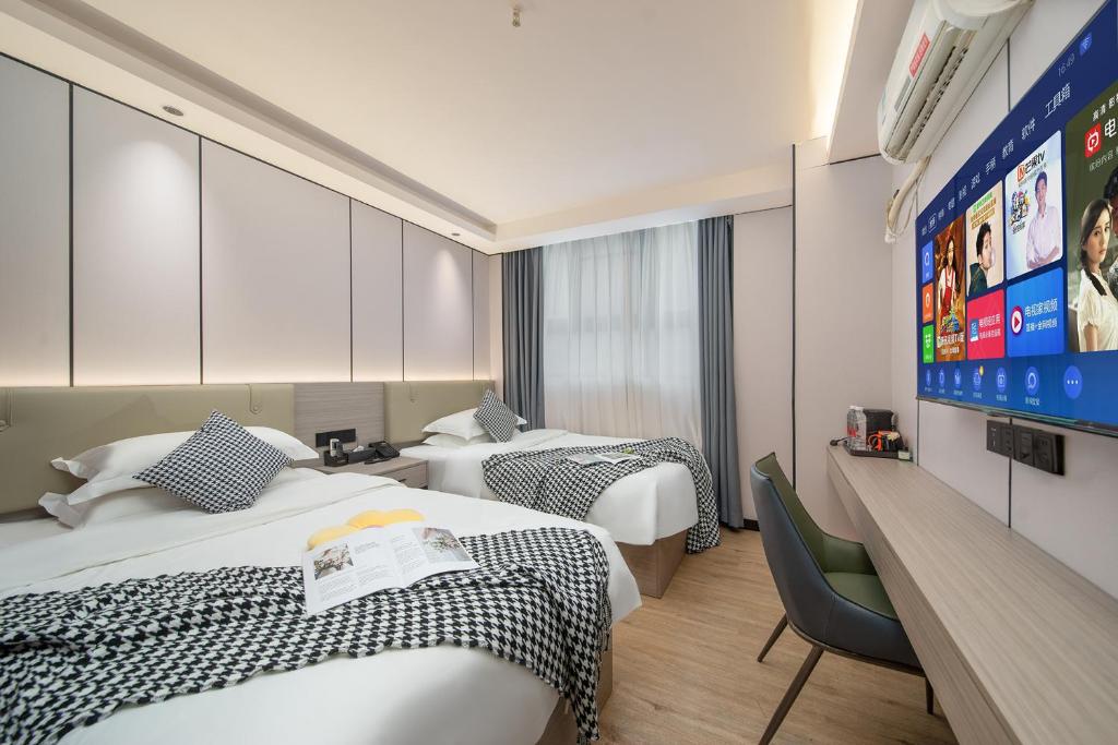 Katil atau katil-katil dalam bilik di Meiye Hotel-Guangzhou Dongpu TianheCity - Canton Fair
