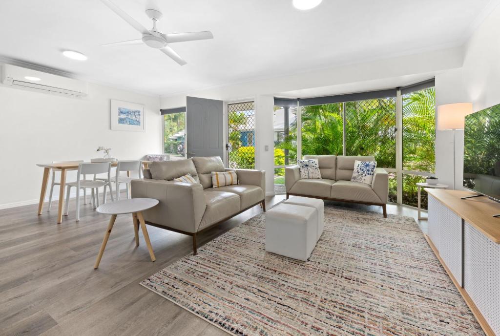 a living room with a couch and a table at 2 Bedroom Villa In Tropical Resort in Noosaville