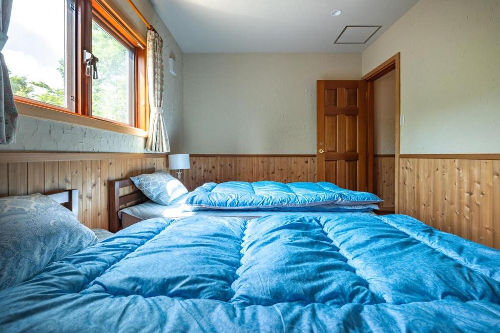 Postel nebo postele na pokoji v ubytování Nasu Grand Lodge