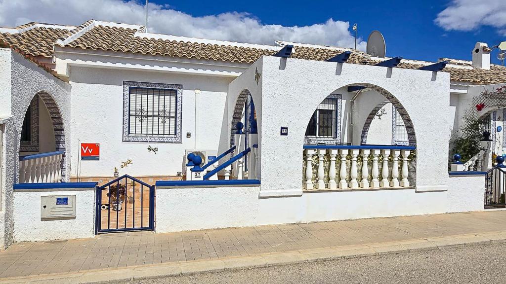 a white house with a gate and a fence at Villa Bonita in Mazarrón