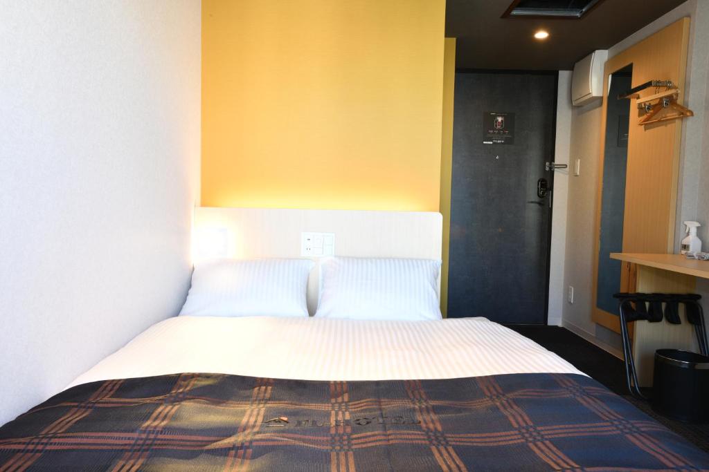 Postel nebo postele na pokoji v ubytování FL Hotel Asakusa