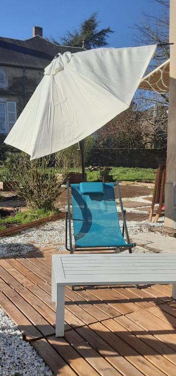 une chaise et un parasol sur une terrasse en bois dans l'établissement Nature et Balnéo en Bourgogne, à Dun-sur-Grandry