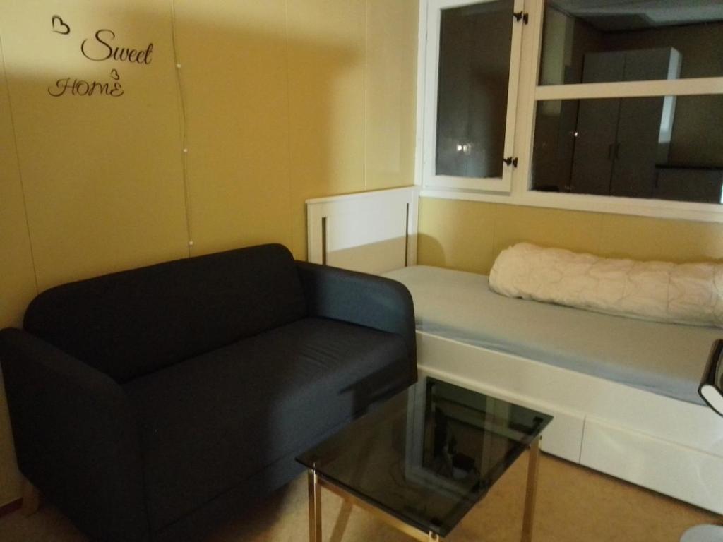 a living room with a couch and a window at Cozy room away from home in Åmot