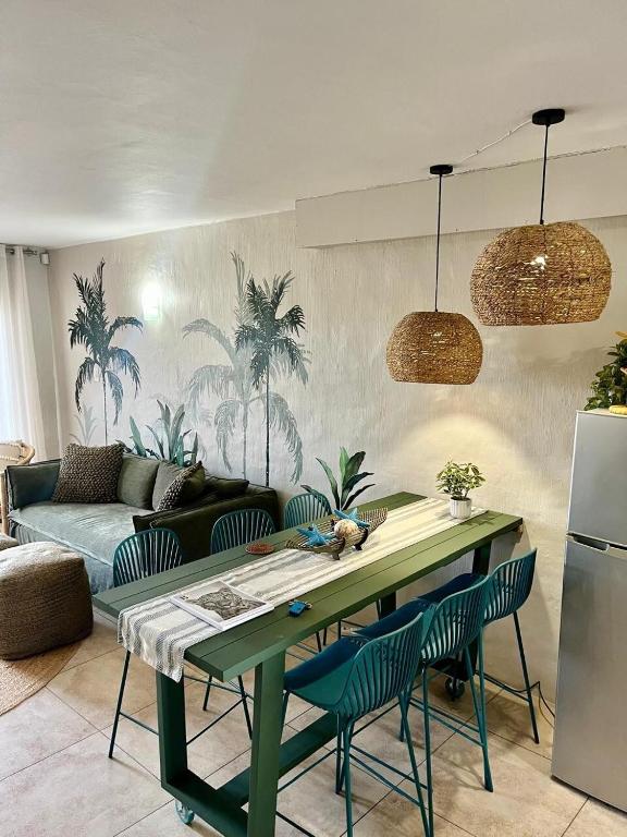 a living room with a green table and chairs at Palms Beach Apartment- Seaviews in Port Alfred