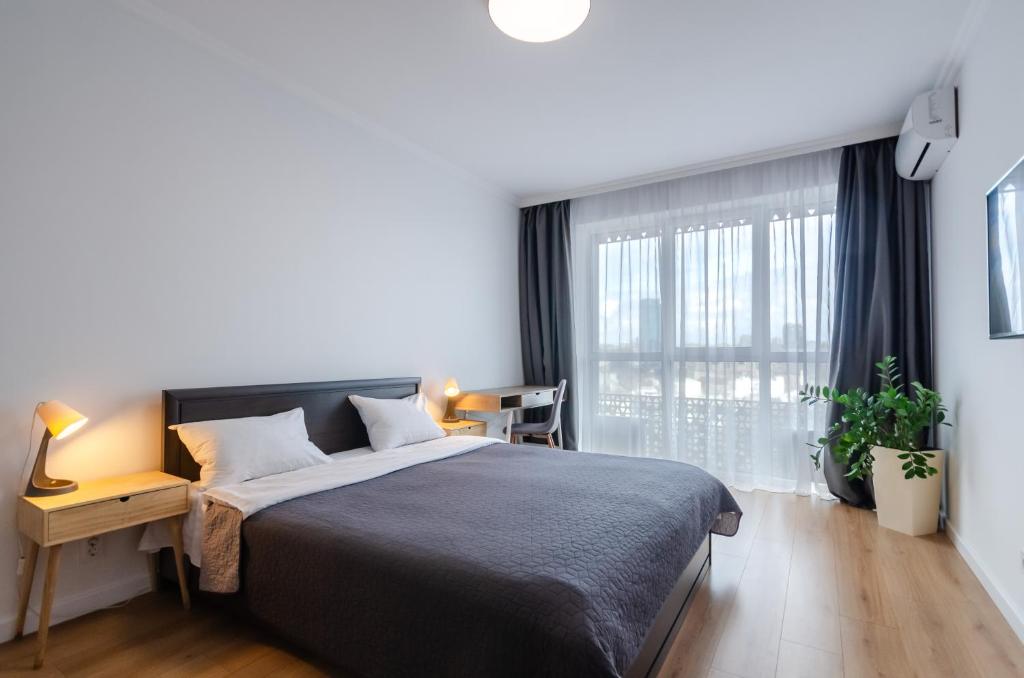 Postel nebo postele na pokoji v ubytování Petrovdom Apartment 7-27 in RC Kvartet, 16Г Vasyl Lypkivskyi Street