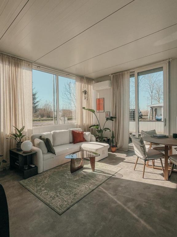 a living room with a couch and a table at The Creative Boat in Lithoijen