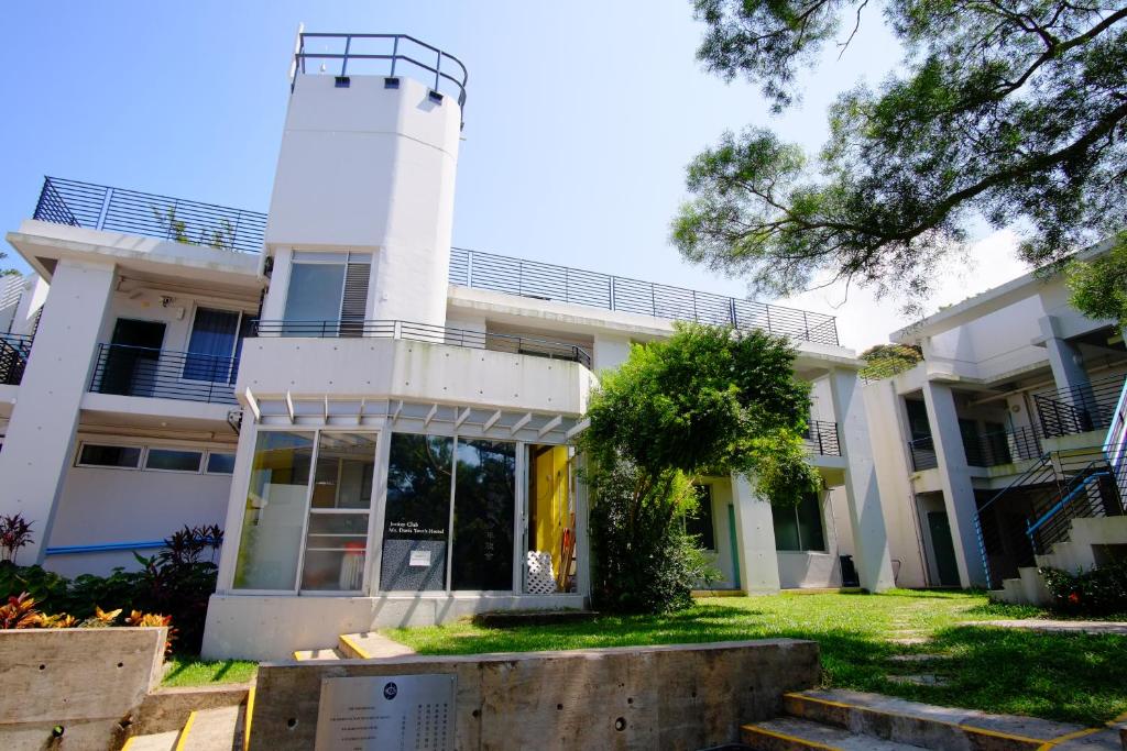 a white building with a tower on top of it at YHA Jockey Club Mt. Davis Youth Hostel in Hong Kong